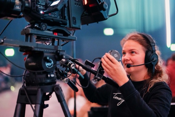 A camera operator wearing a headset at work.