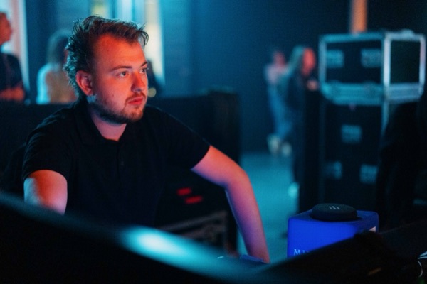 An operator at work in blue light.